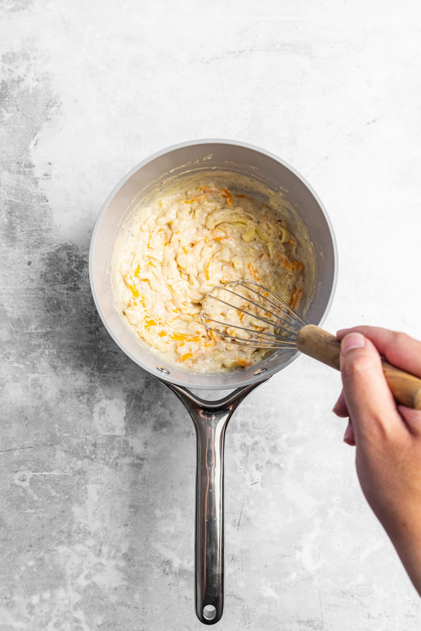 Cheese being whisked into the roux.