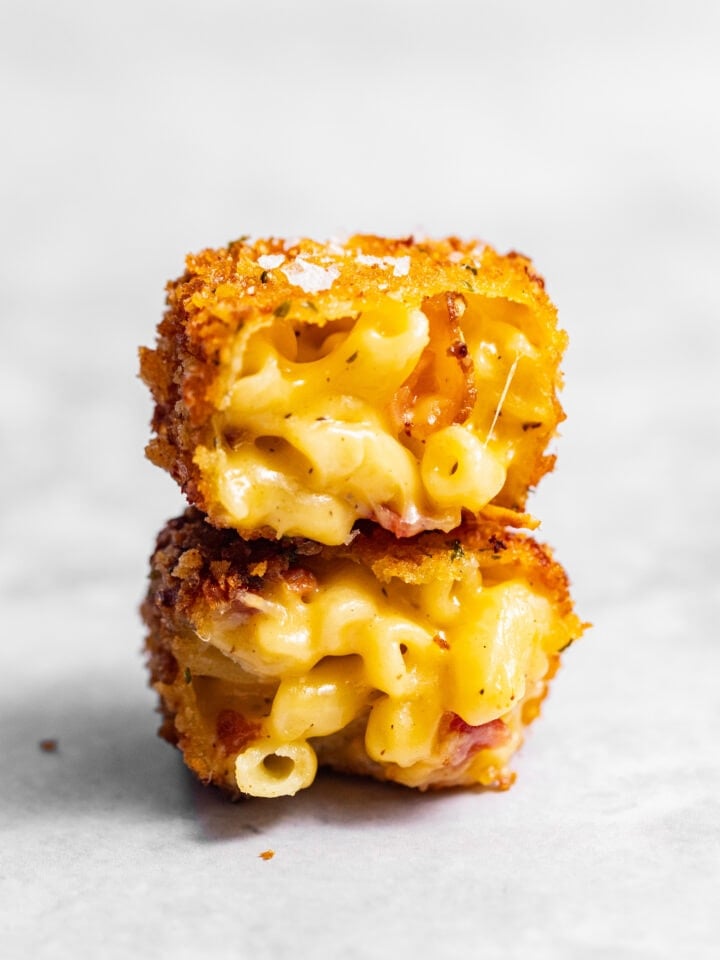 Crispy Fried Homemade Mac and Cheese Bite cut in half and stacked on top of each other.