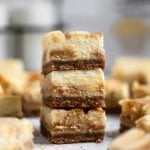 Close up salted caramel cheesecake bars stacked