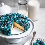 Small 6-inch vanilla cake sliced with blue monochromatic decorative frosting