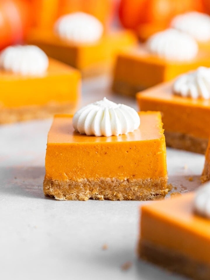 Close up of No-Bake Pumpkin Pie Bars with whipped cream piped on top
