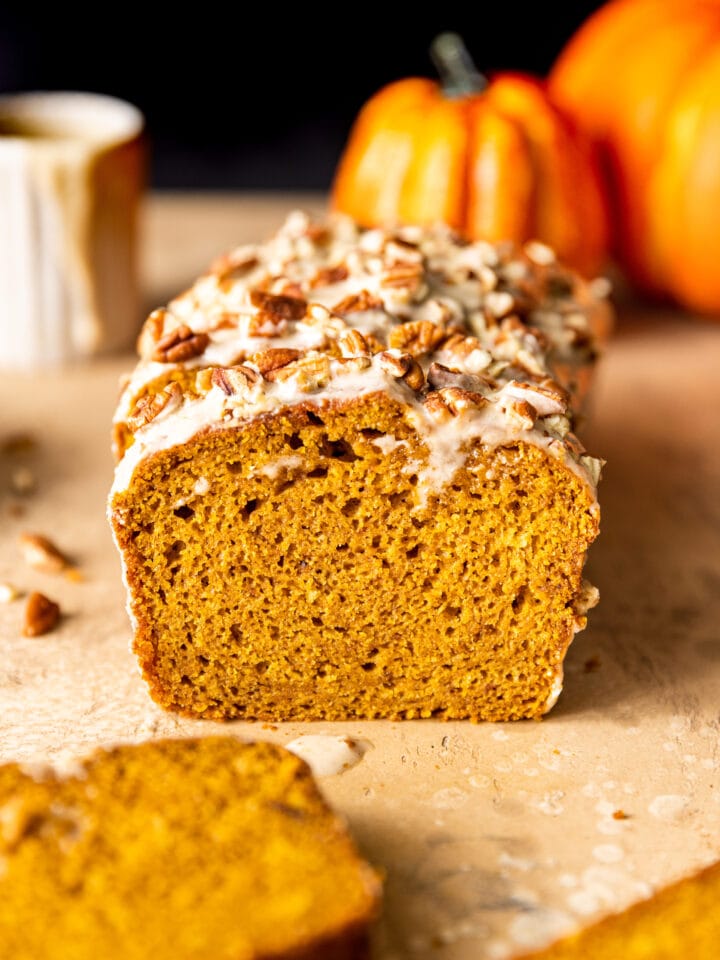 Slices of Maple Glazed Pumpkin Bread with chopped pecans on top