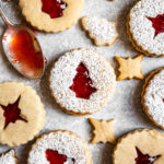 Close up of Strawberry Cardamom Linzer Cookies dusted with powdered sugar