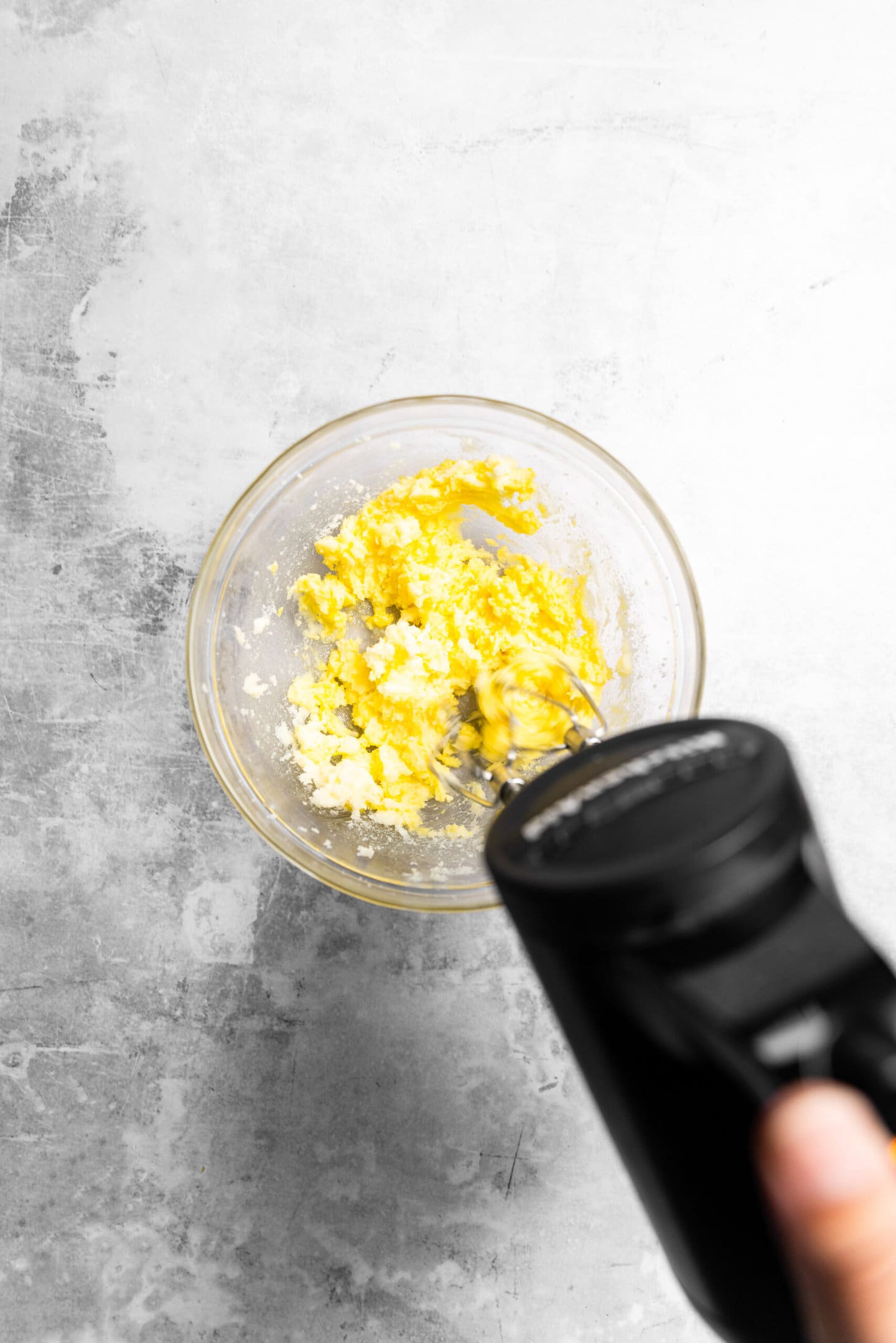 Egg and vanilla being beaten into butter and sugar mixture.
