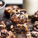 Gooey Small Batch Oreo Blondies stacked on top of each other next to a glass of milk