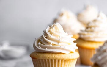 Small Batch Vanilla Cupcakes with vanilla bean buttercream and sprinkles on top.