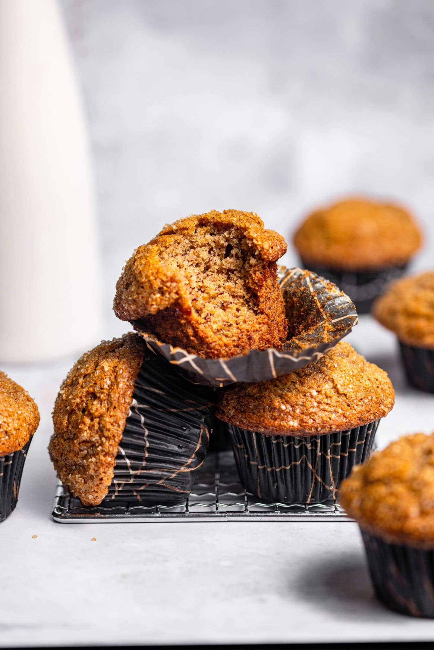 A stack of banana muffins with a bite missing from the top one.