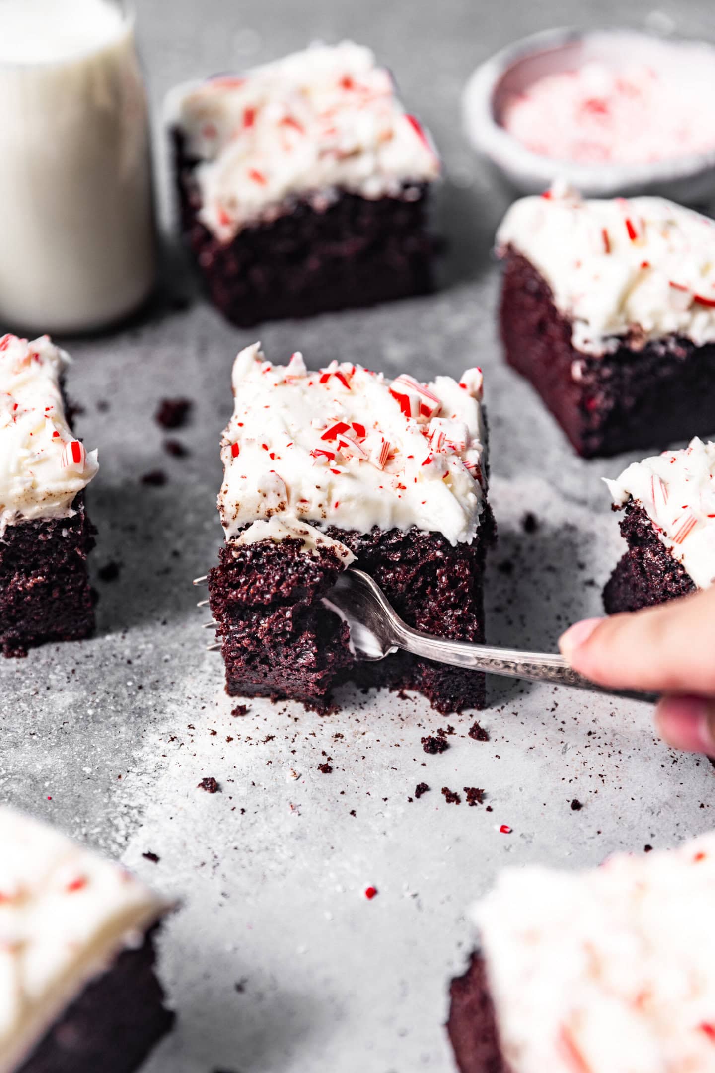 A fork taking a bite out of a slice of chocolate peppermint cake. You can see how moist the cake interior is.