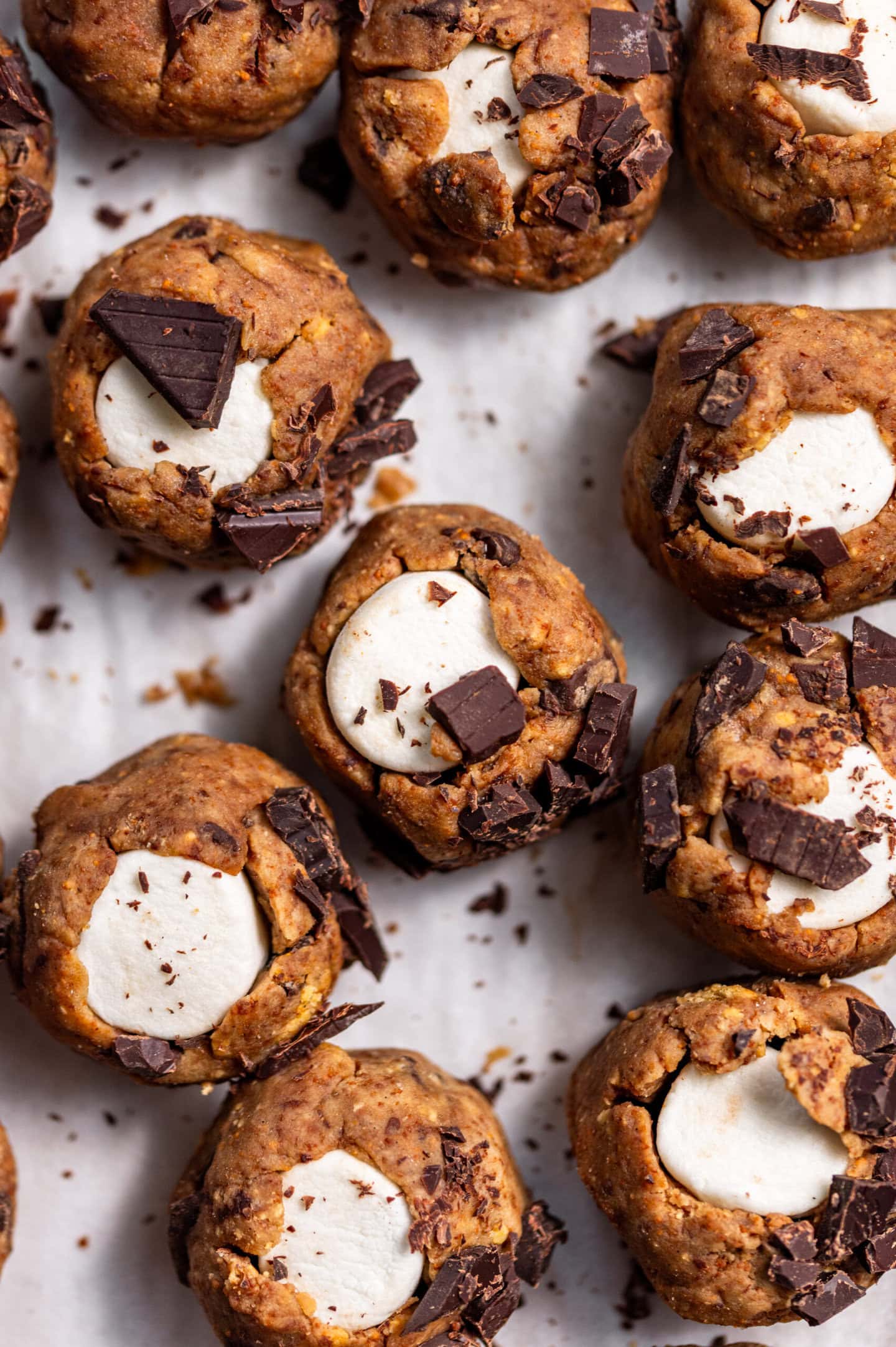 Unbaked Marshmallow-stuffed s'mores cookie dough on top of a baking tray.