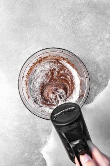 Dry ingredients being incorporated into brownie batter.