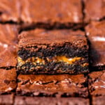 Close up of Biscoff brownies showing fudgy texture with a cookie butter layer in the center.