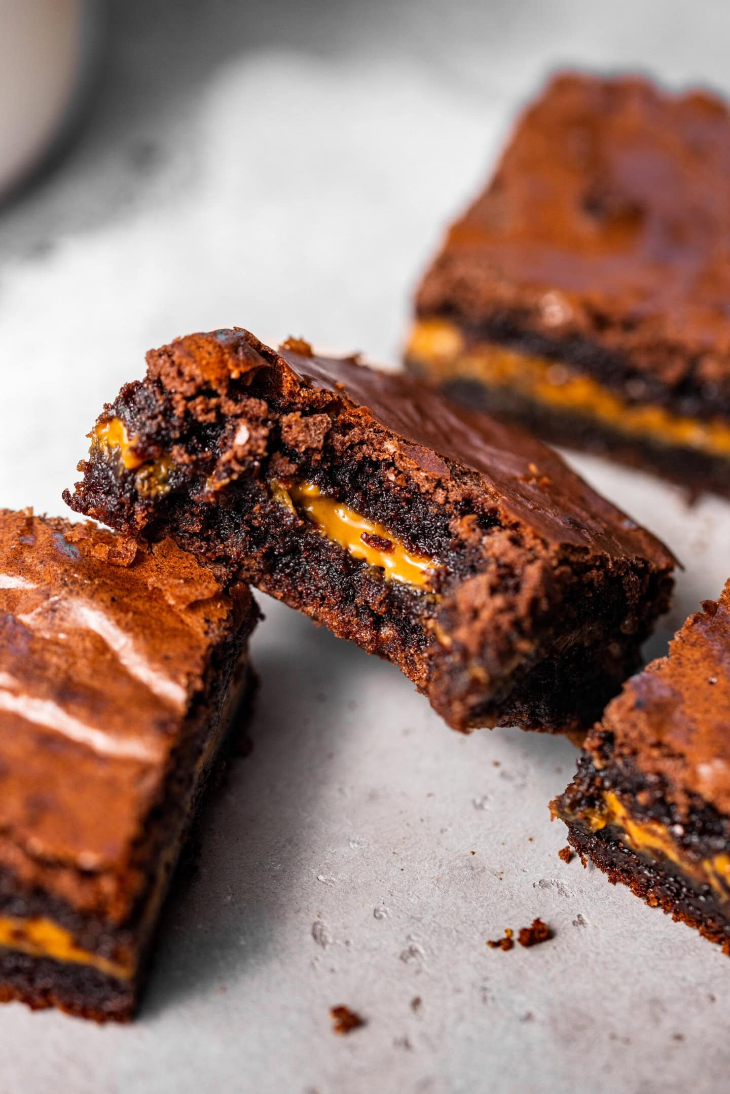 Close up of biscoff brownies with a bite missing from one showing off molten cookie butter center.