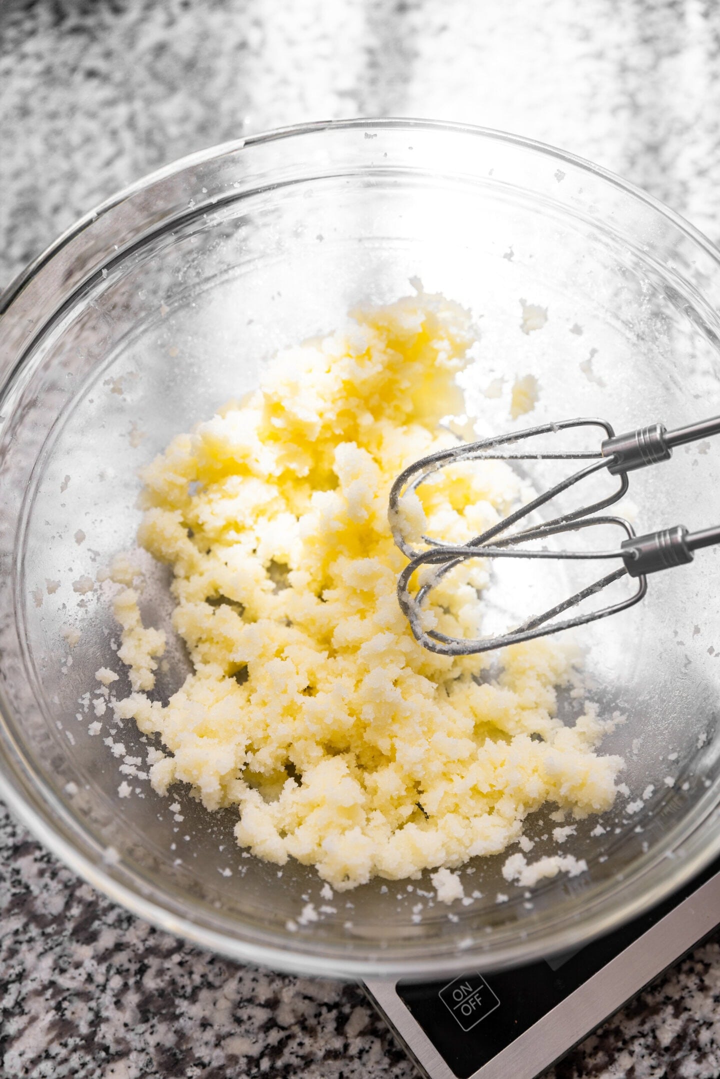 Butter and sugar being beaten together with a hand mixer.