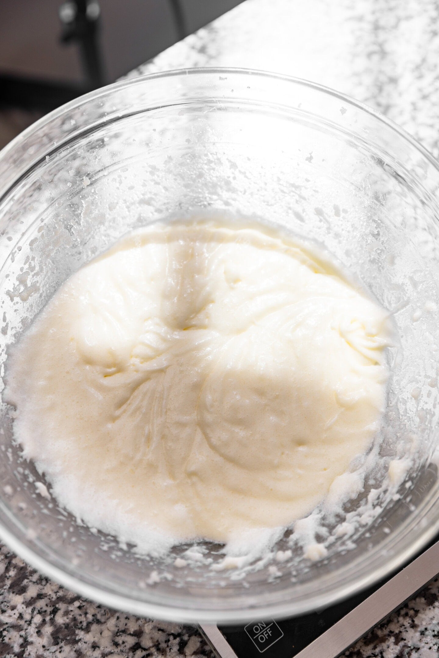 Wet ingredients being incorporated into the butter and sugar mixture.