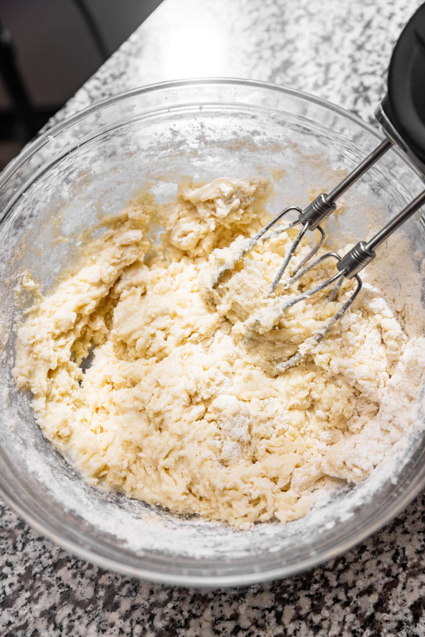 Dry ingredients being beaten into the wet ingredients.