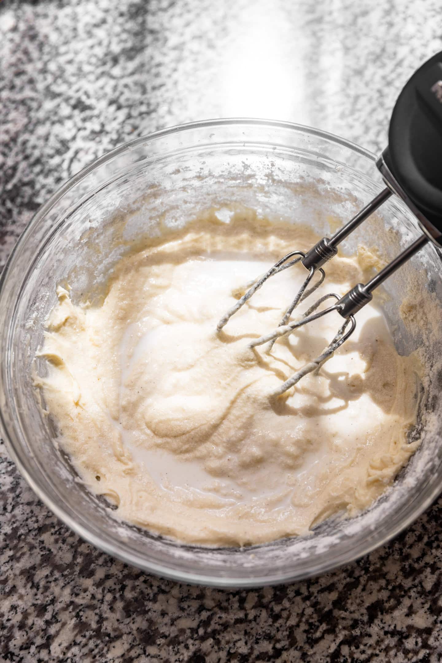 Milk being incorporated into the cake batter.