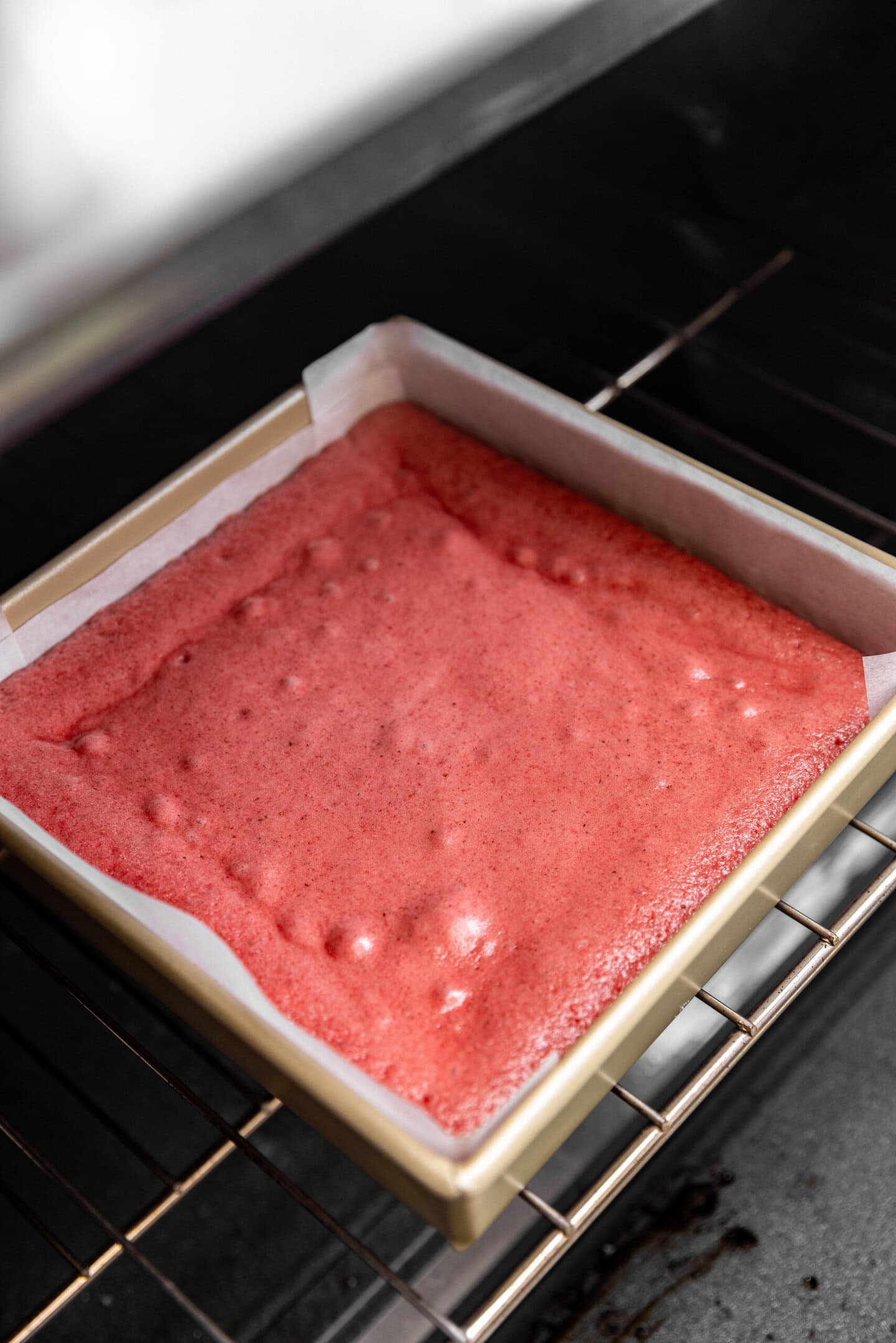 Strawberry cake being baked up inside of the oven.