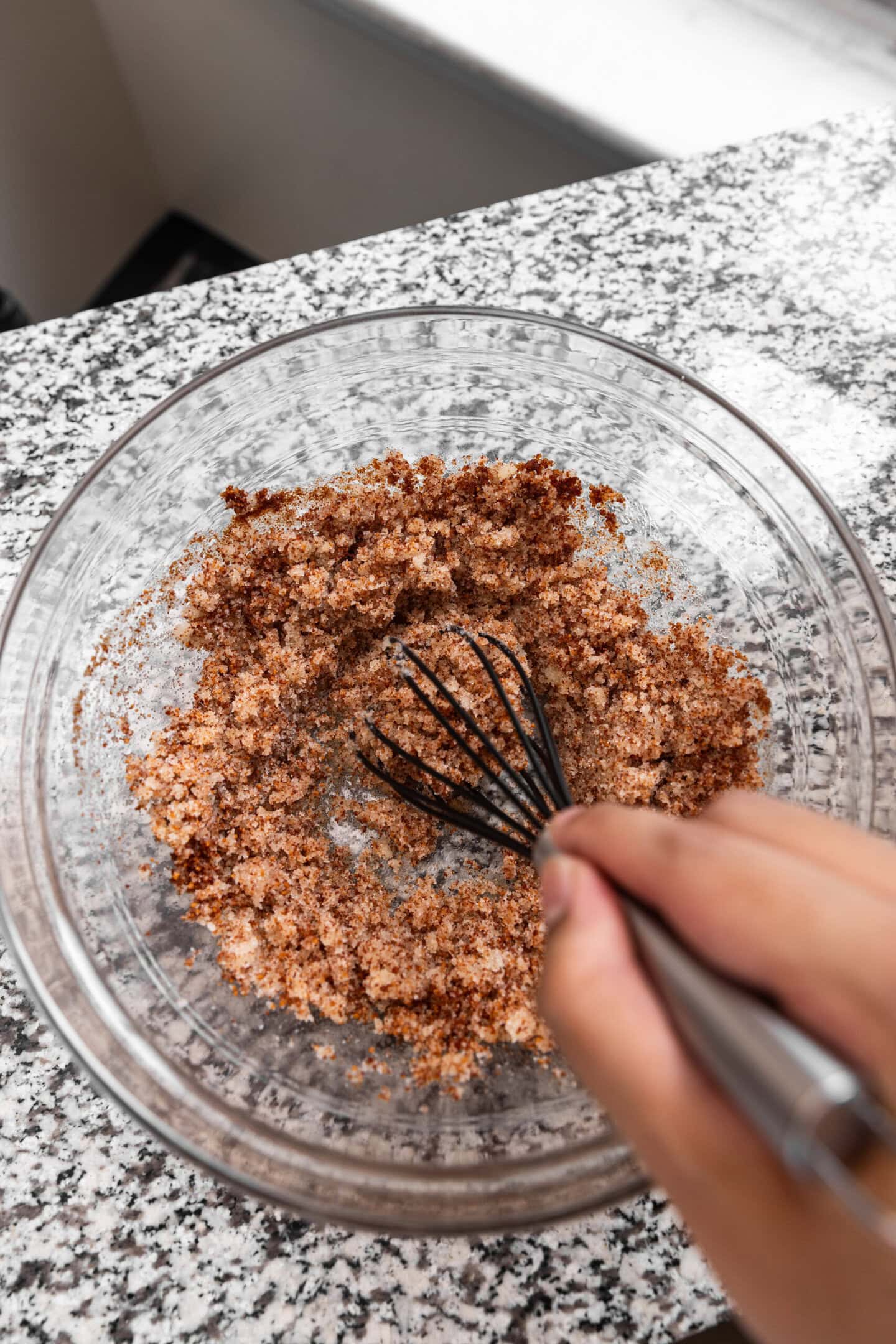 Sugar being whisked into the brown butter mixture.