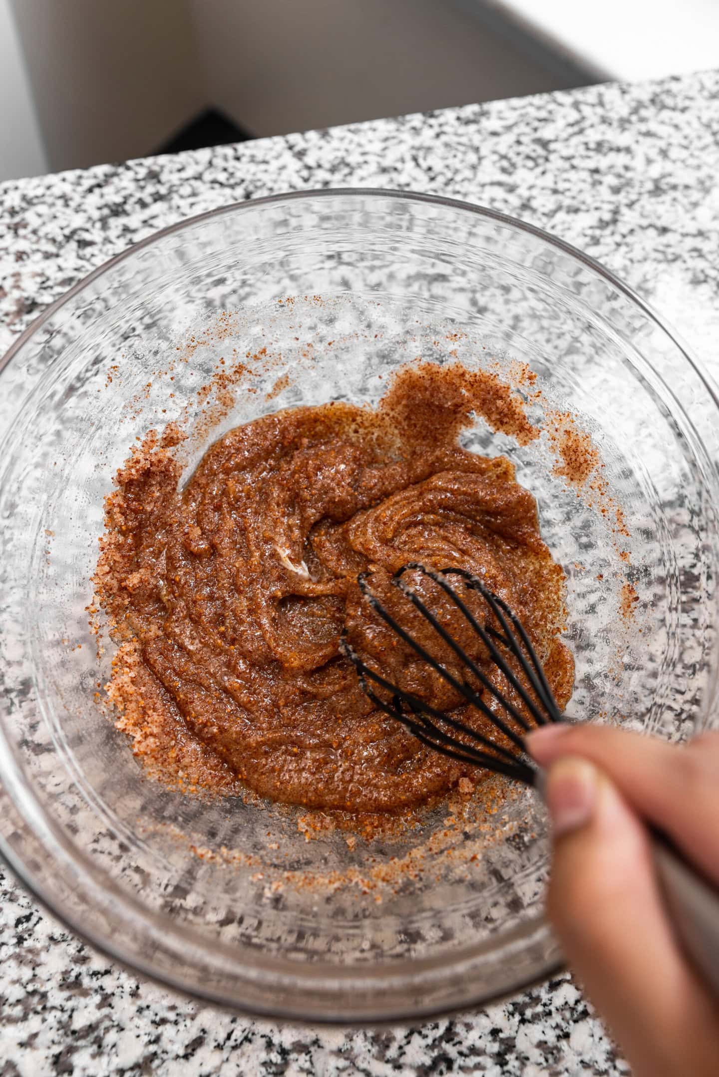 Egg and vanilla being whisked into the butter and sugar mixture.
