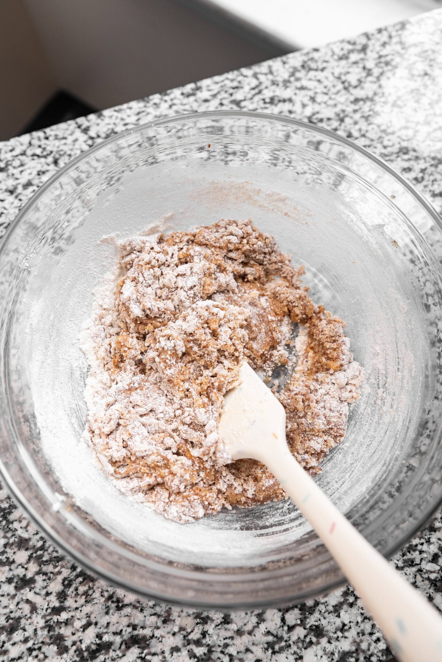 Dry ingredients being folded into the wet ingredients to form the brown butter sugar cookie dough.